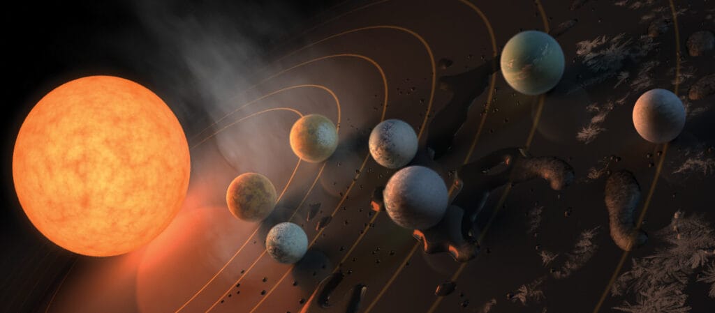 Wizja artystyczna układu TRAPPIST-1 z widoczną gwiazda-matką i planetami, z lodowatą stroną nocną i rozżarzoną dzienną